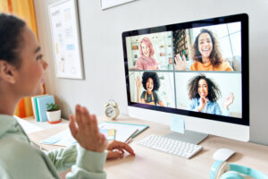 Women in virtual meeting writing letters to undecided voters.